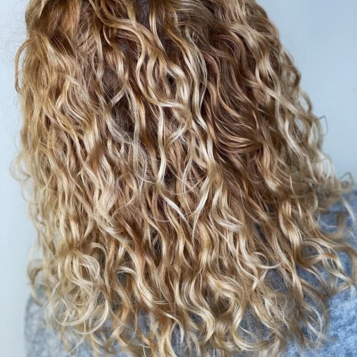 Langt krøllet hår efter professionel Curly Cut behandling hos Fashion Cut